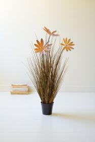 ARTIFICIAL GRASS WITH LEAVES IN A BLACK PLASTIC POT